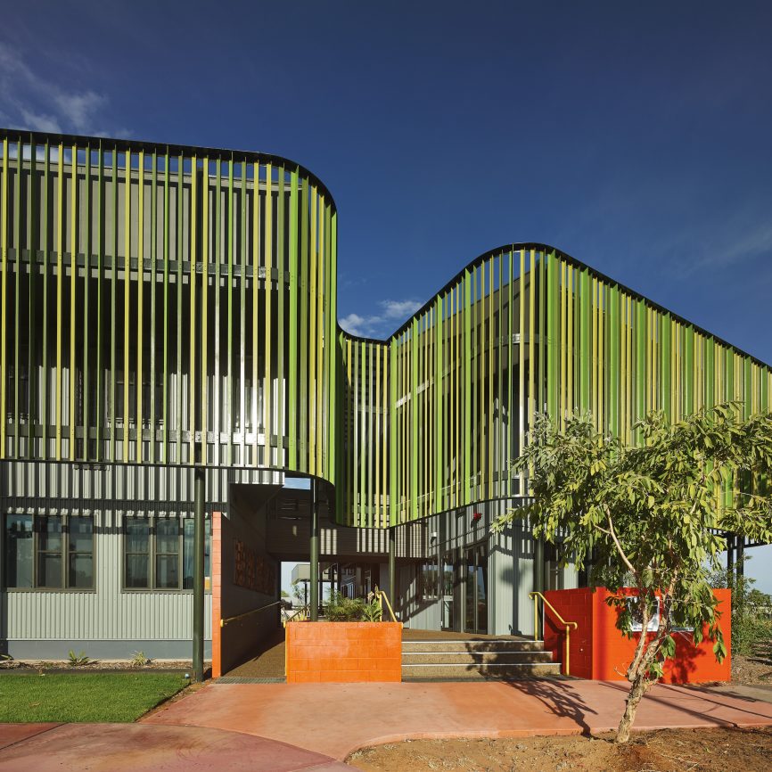 screen creates shaded, non-airconditioned spaces for people to work and gather, and at night the screen glows like a beacon across the town